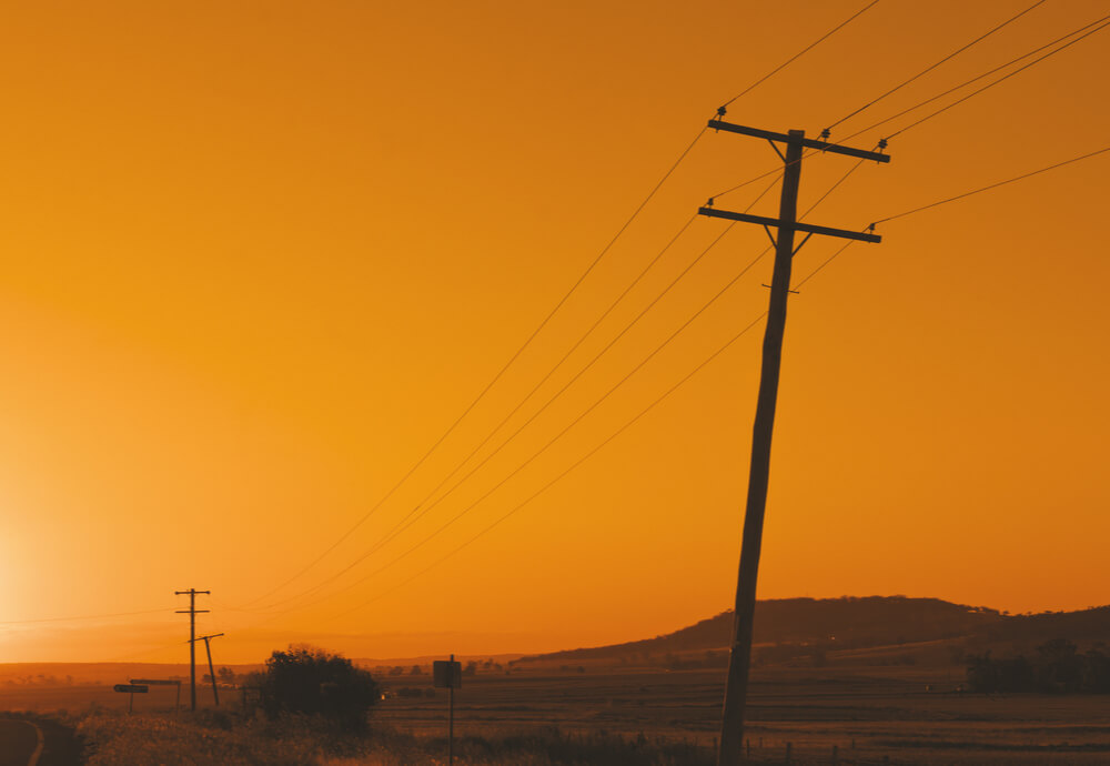 power poles in the Australian outback at sunset