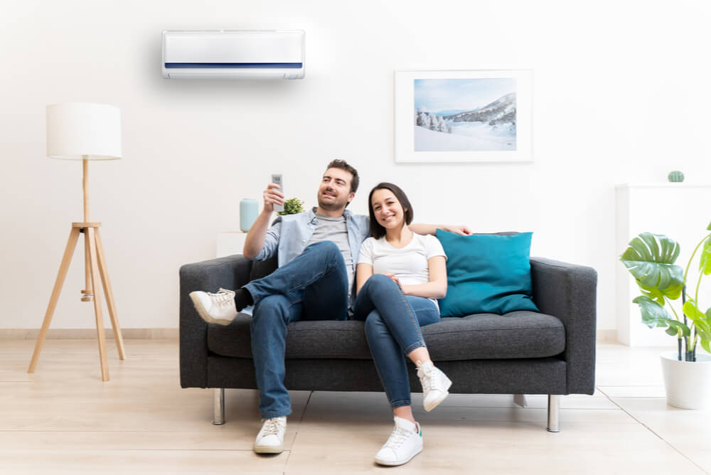 Couple using airconditioner after checking power consumption