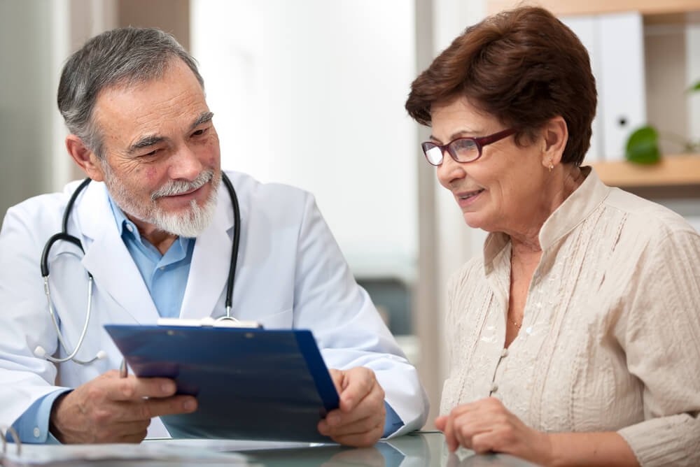 a patient with a specialist discussing health insurance