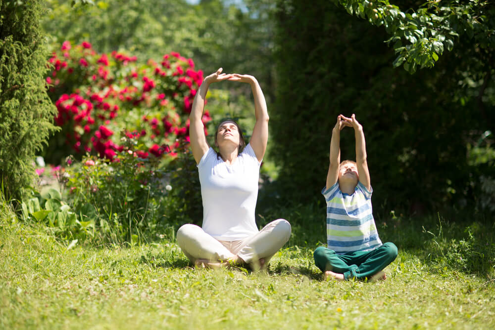 mother and son practicing Tai Chi in a garden