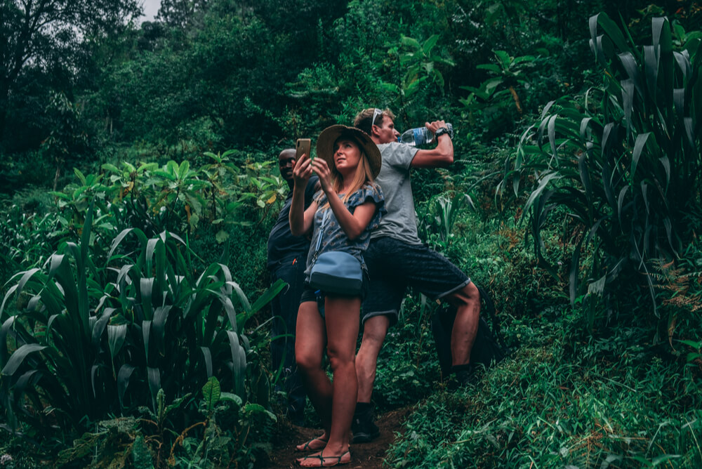 two tourists taking photos in a jungle with travel insurance covering medical evacuation repatriation