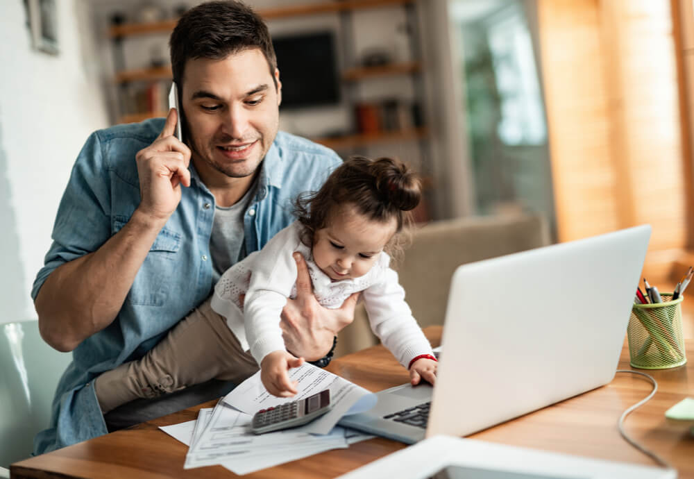 a dad on the phone updating his insurance policy with daughter