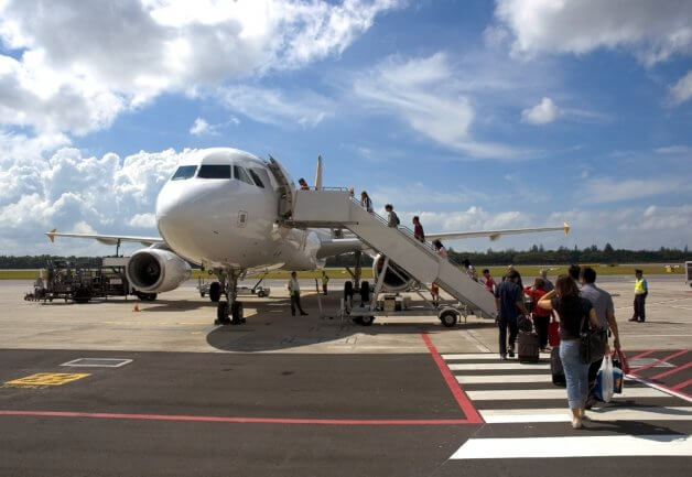 Passengers crossing the tarmac to board a plane