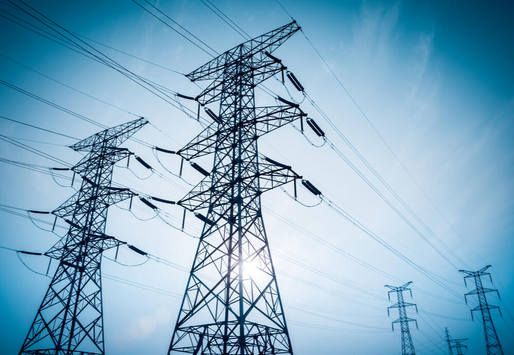 Power lines stretching across blue sky