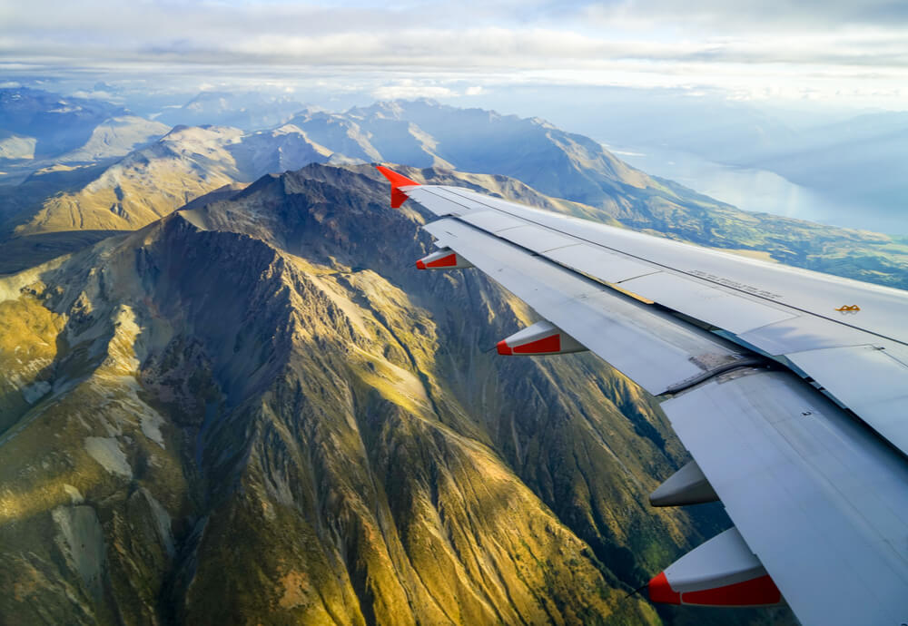 Plane flying over mountains near Queenstown, New Zealand