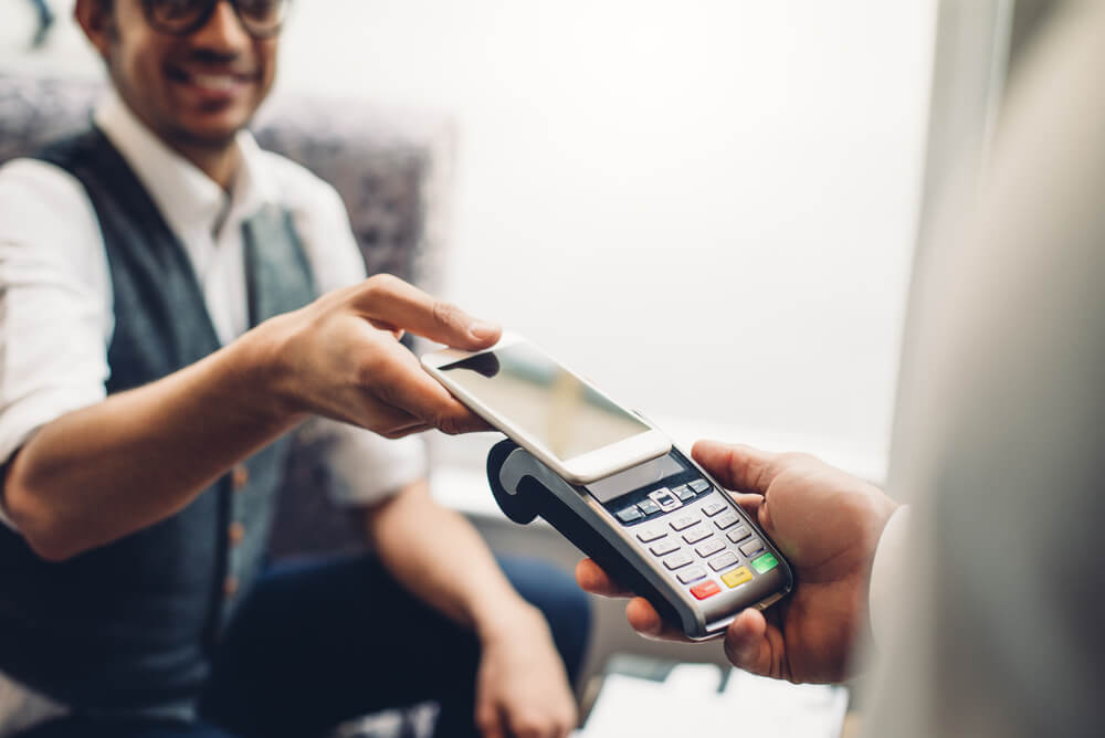 Man using phone to pay