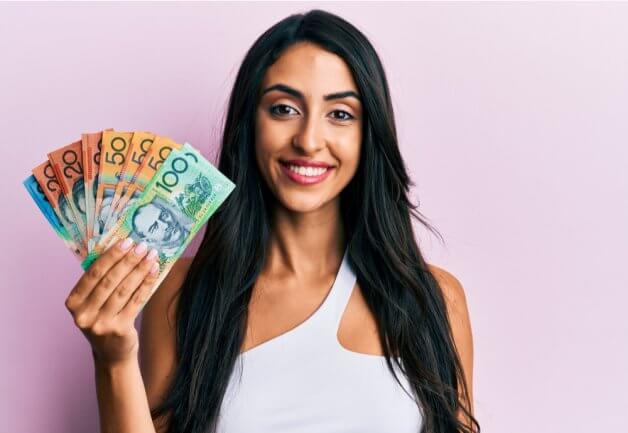 Smiling woman holding money