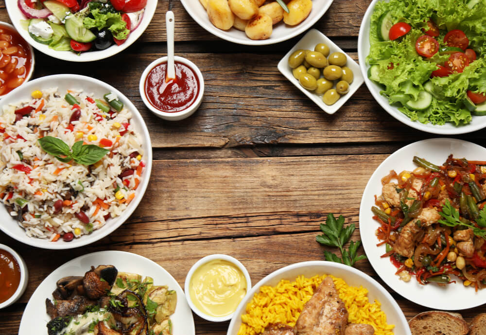 Plates of various food on a wooden table