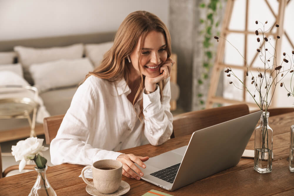 a smiling woman working from home