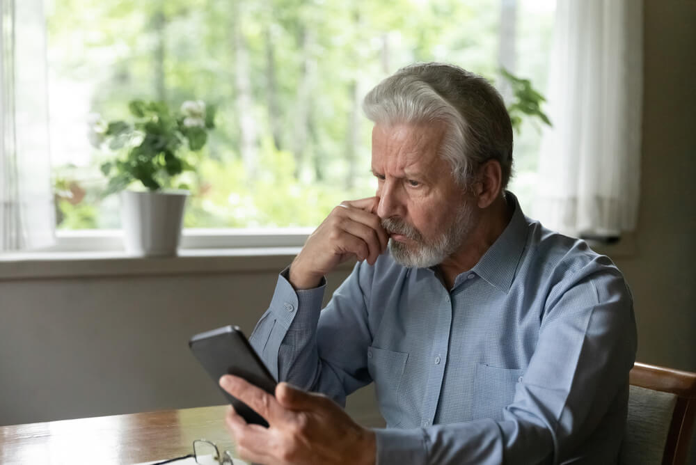 angry old man upset that he fell for a phishing scam