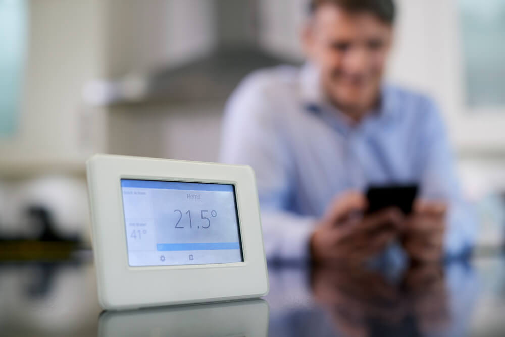 man connecting his smart meter to the smart grid