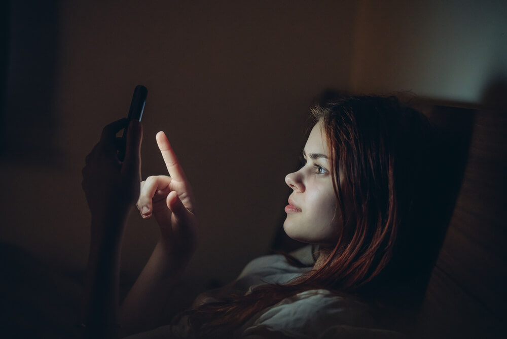 Woman getting storm update during blackout