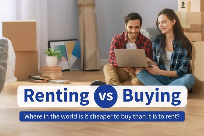 Renting vs Buying social image of two people on laptop surrounded by moving boxes