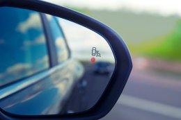 a close up of a blind spot monitor indicator on a car wing mirror