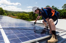 man installing rooftop solar