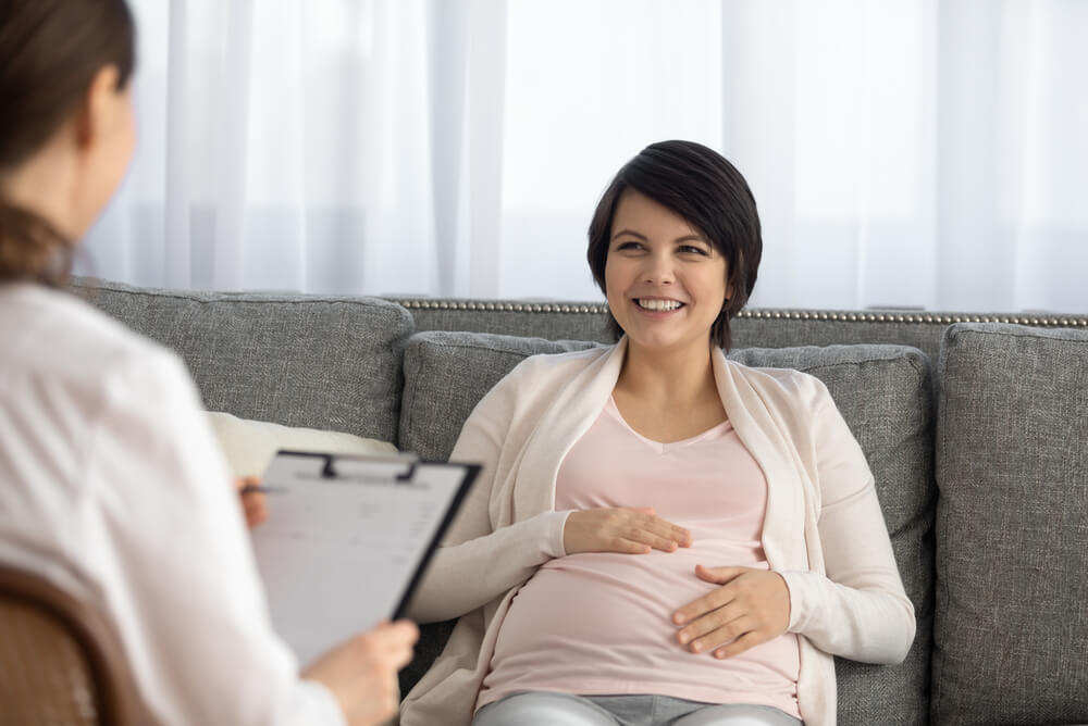 Pregnant woman talking to doctor