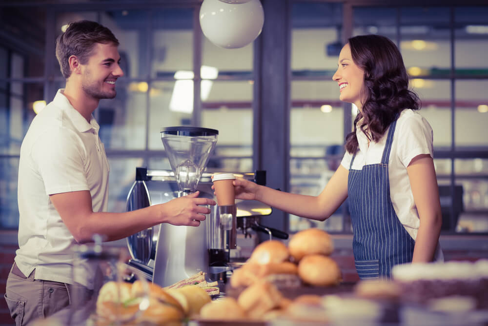 a waitress serving coffee in a cafe insured with public liability insurance