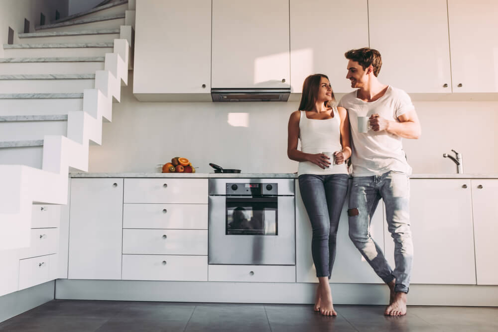 A couple in the kitchen of a modern apartment