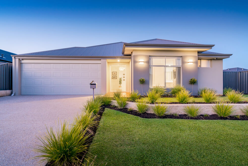 A modern house with lights on at dusk