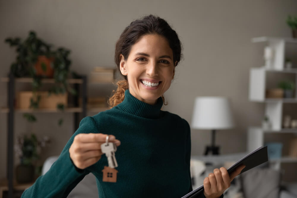 A female landlord holding out house keys