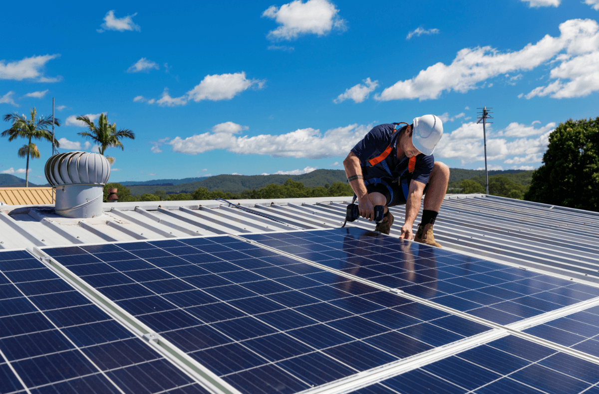man installing solar panels