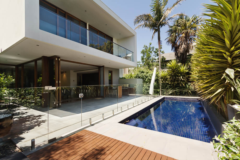 A modern house pool area surrounded by trees