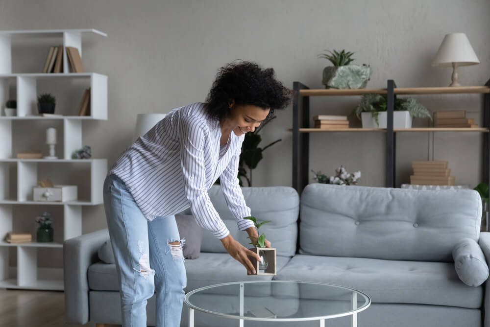 A woman arranging decor inside her home