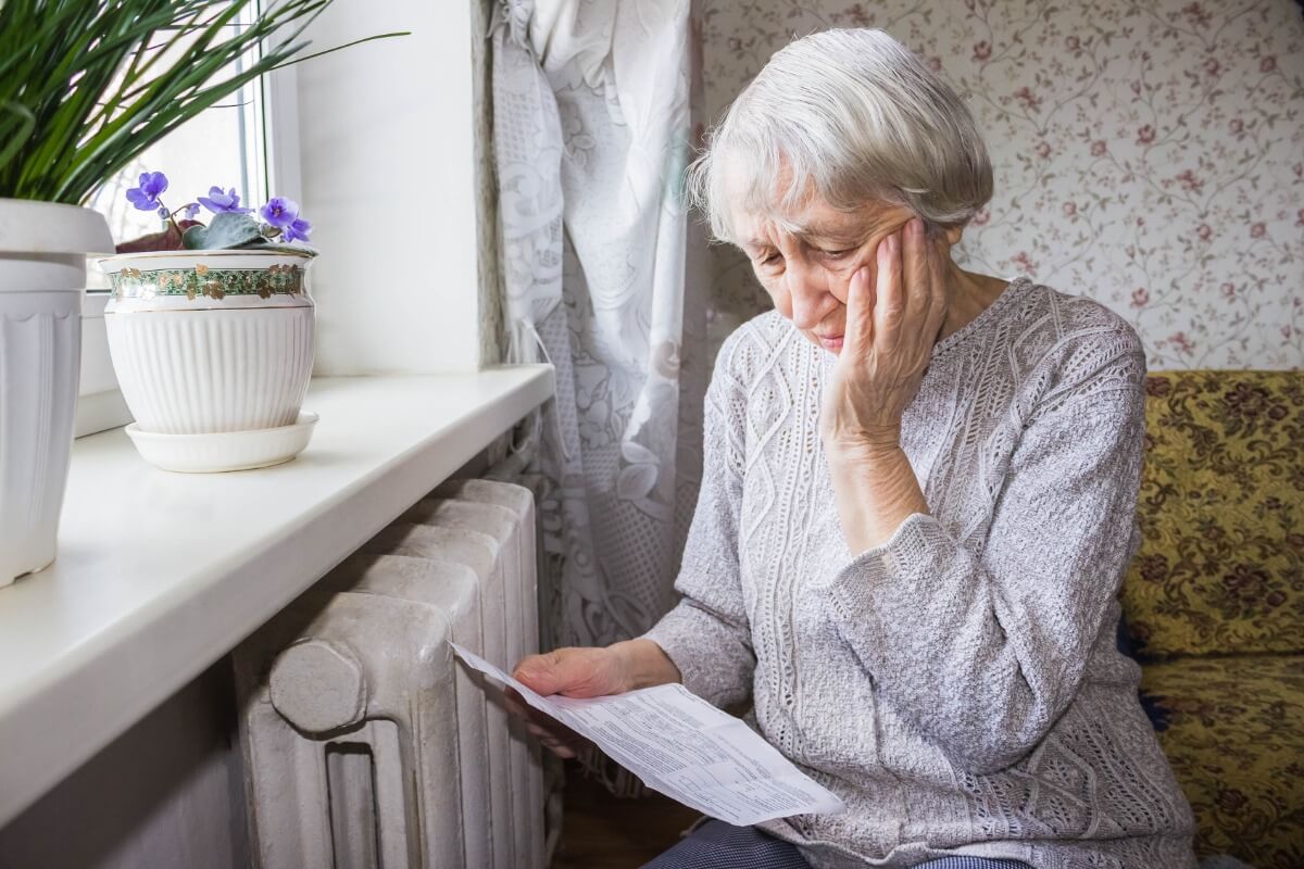 woman reading letter telling her gas prices are increasing