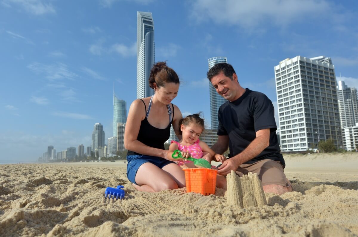 family playing on the beach in queensland
