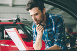 A man reviewing his car insurance premium increase notice