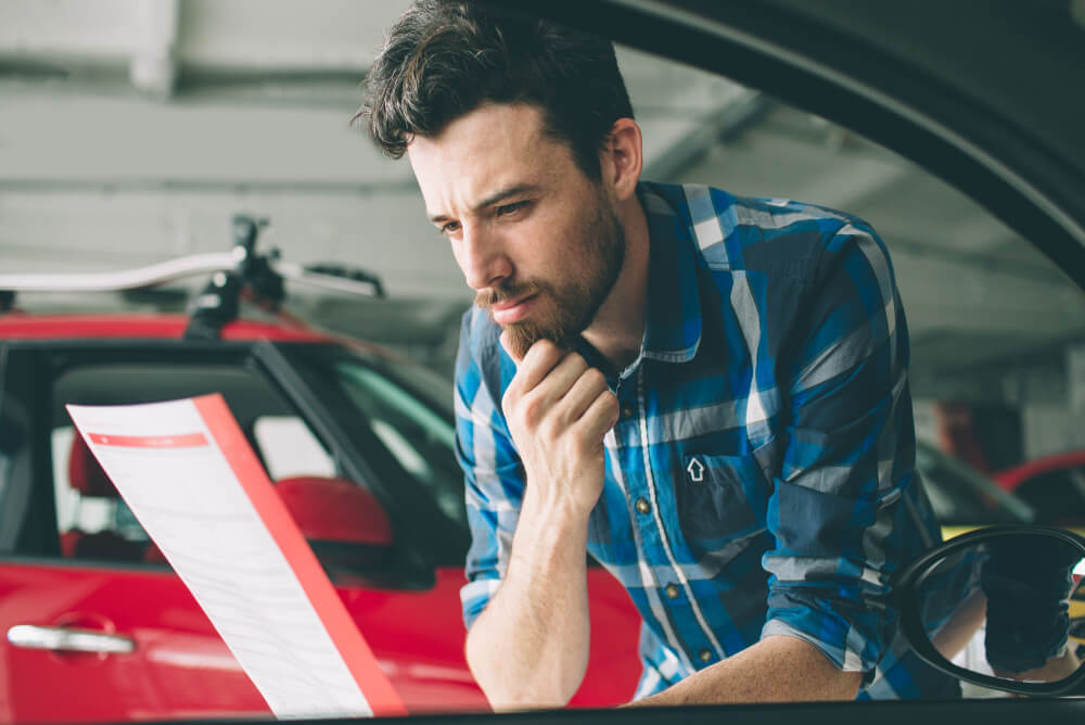 A man reviewing his car insurance premium increase notice