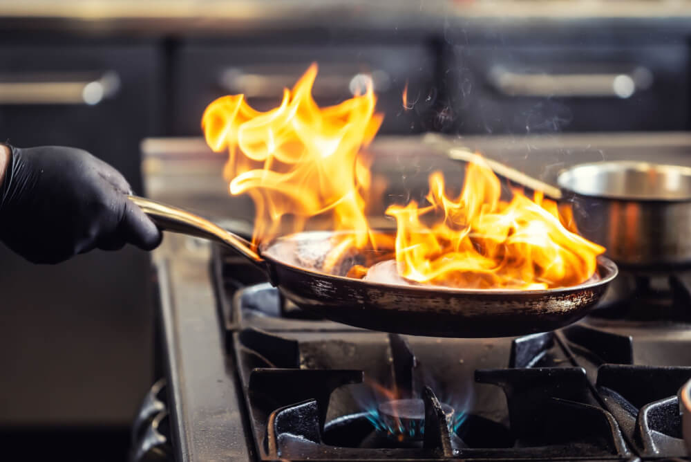 Chef cooking on commercial gas stove