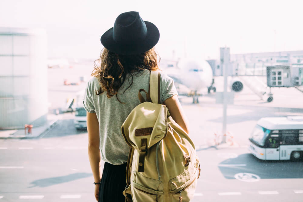 Woman at airport with trip delays