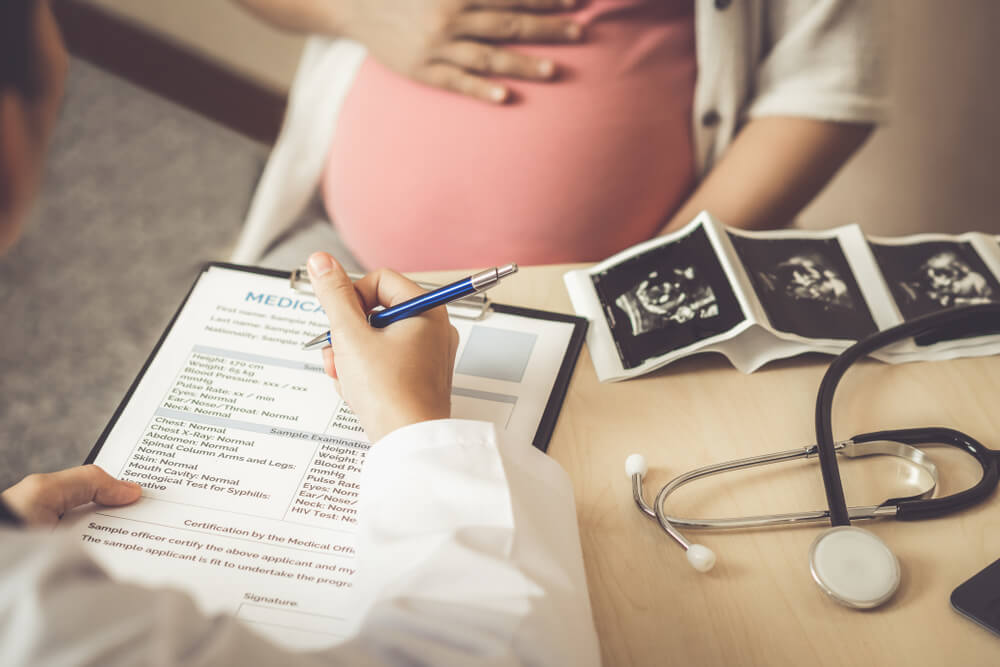 Pregnant woman visiting the doctor before travelling