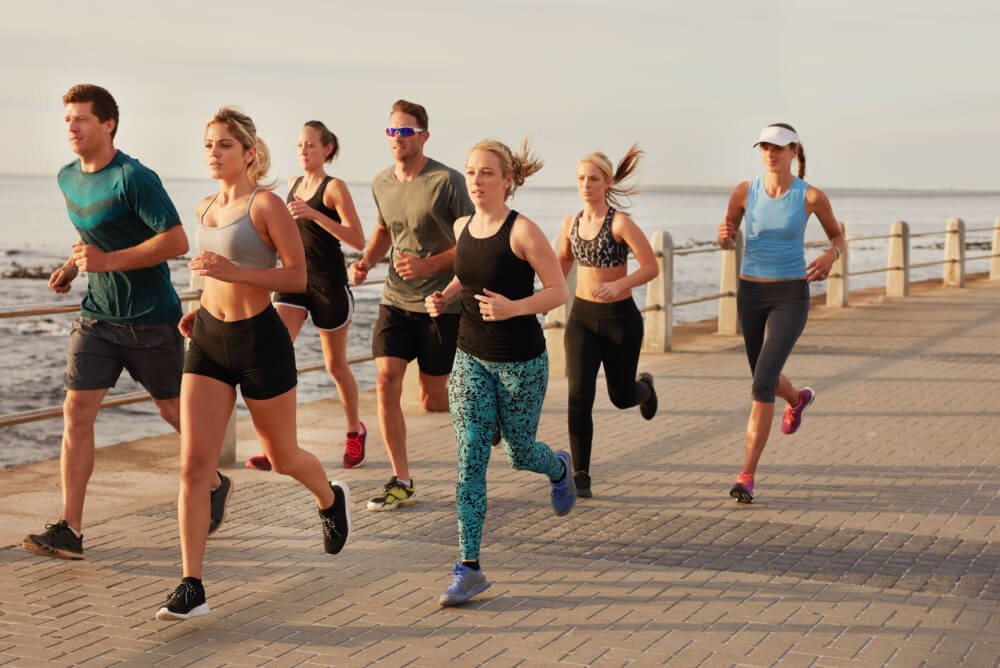 Team run on the beach safely with health insurance for sports injuries