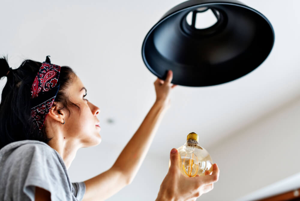 Woman changing a lightbulb
