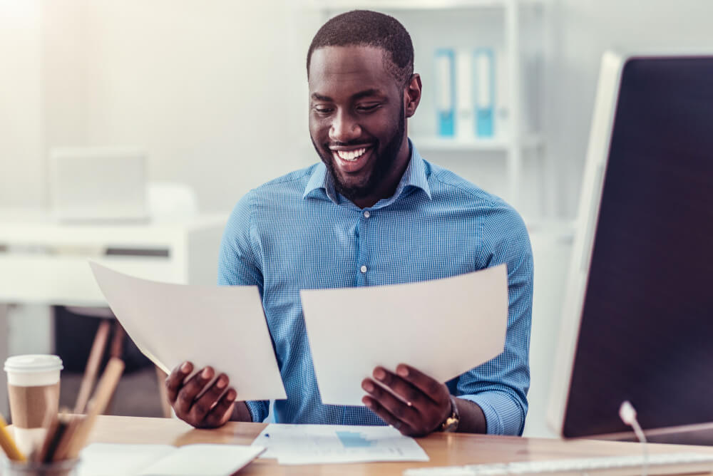 man happy and holding documents