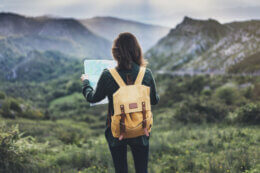 Woman hiking with comprehensive travel insurance