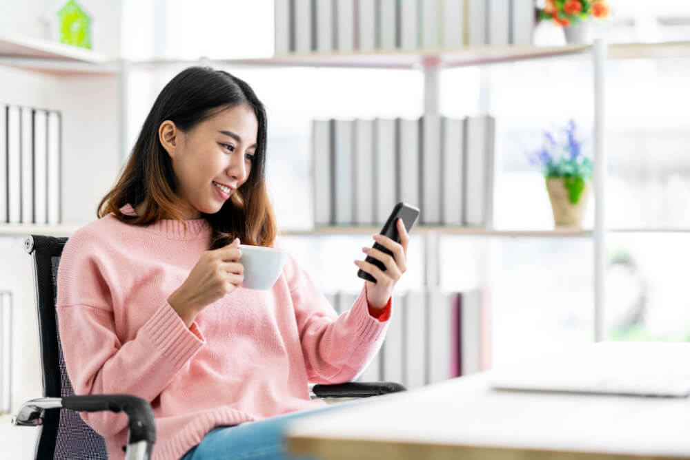 Woman using her phone at home