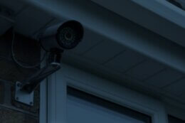 a security camera by a window on a house