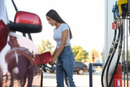 petrol prices for australia day as woman fills up car