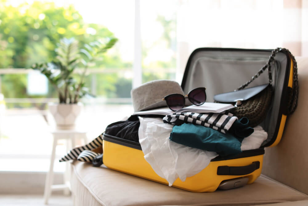Yellow suitcase packed for an overseas trip
