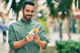 Man holding cash notes