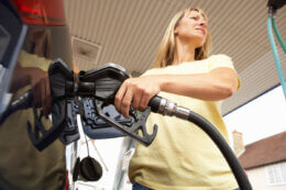 woman filling car with petrol easter long weekend