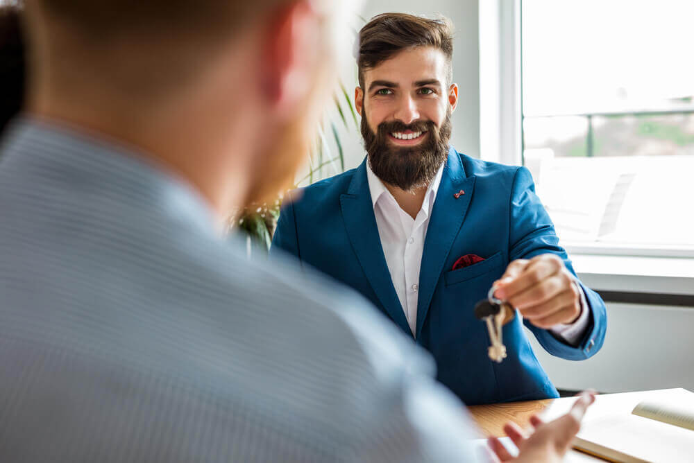 Agent of landlord handing over property keys