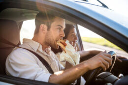 man eating behind the wheel