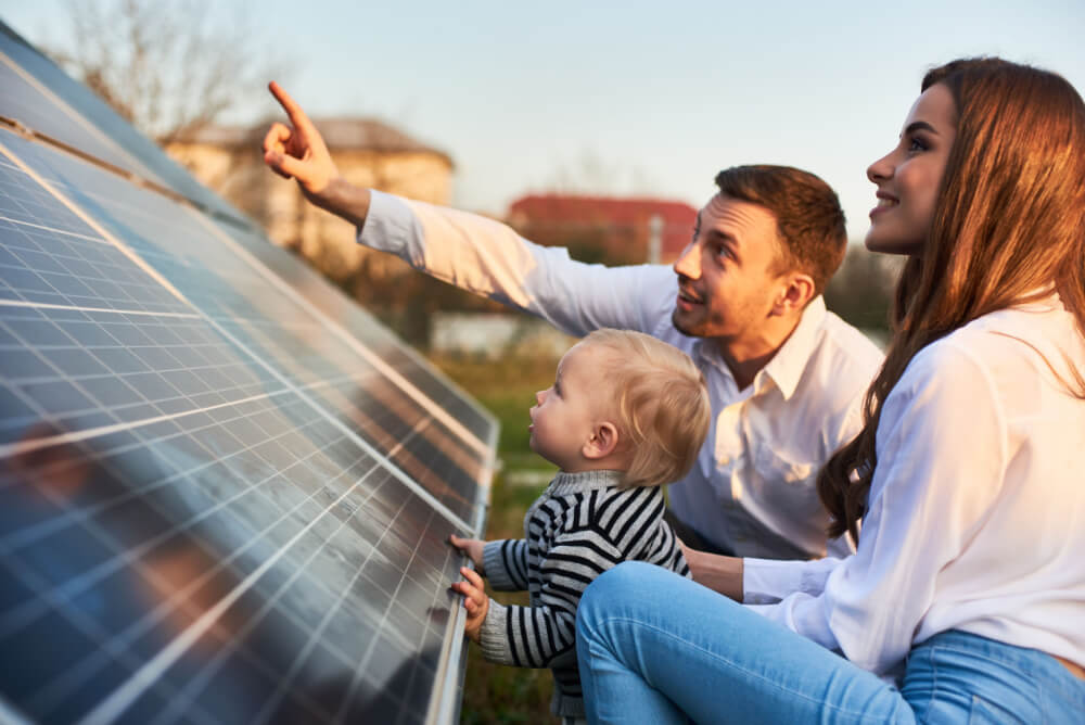 Parents showing their child their new solar panels