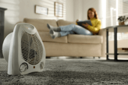 woman using heater in winter