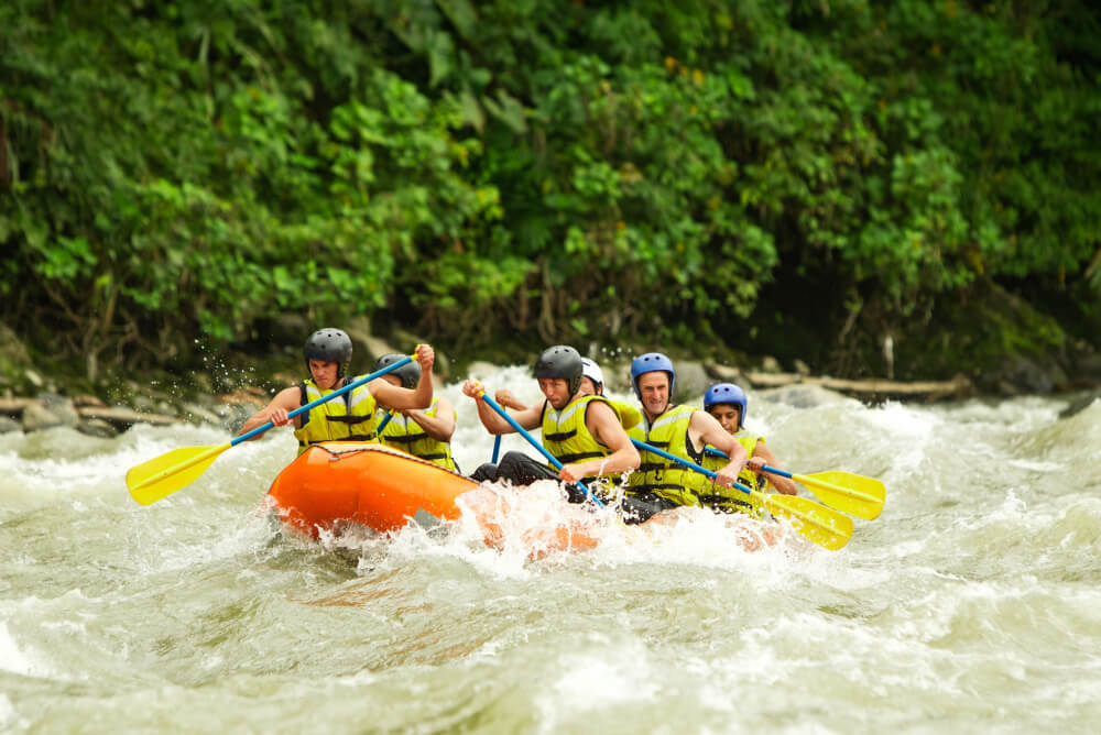 Tourist whitewater rafting with adventure travel insurance in Ecuador