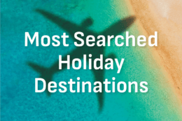 a shadow of a plane over a beach with the words "Most Searched Holiday Destinations"